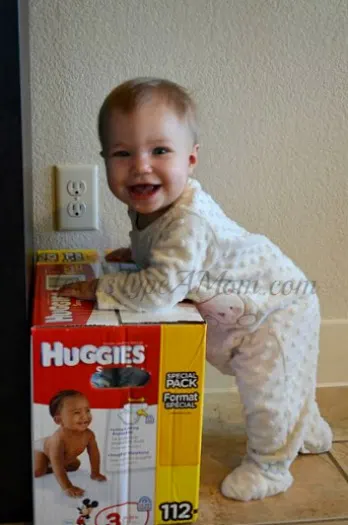 Baby Playing with Huggies Snug and Dry Diaper Box