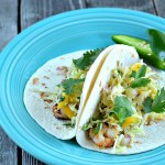 These Grilled Shrimp Tacos with Jalapeno Mango Slaw are fresh and flavorful with just the slightest kick. Perfect for Cinco de Mayo!