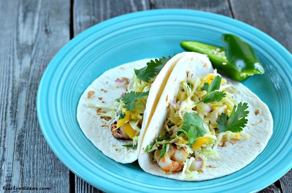 These Grilled Shrimp Tacos with Jalapeno Mango Slaw are fresh and flavorful with just the slightest kick. Perfect for Cinco de Mayo!