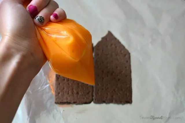 Piping Royal Icing onto Haunted Gingerbread House