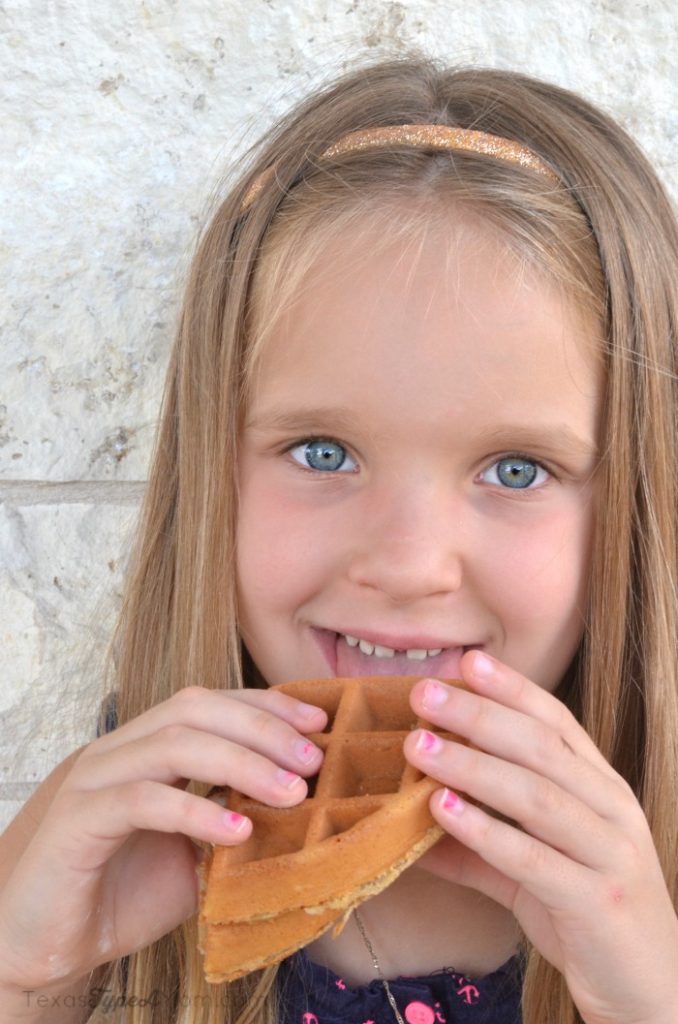 girl eating s'mores waffle sandwich