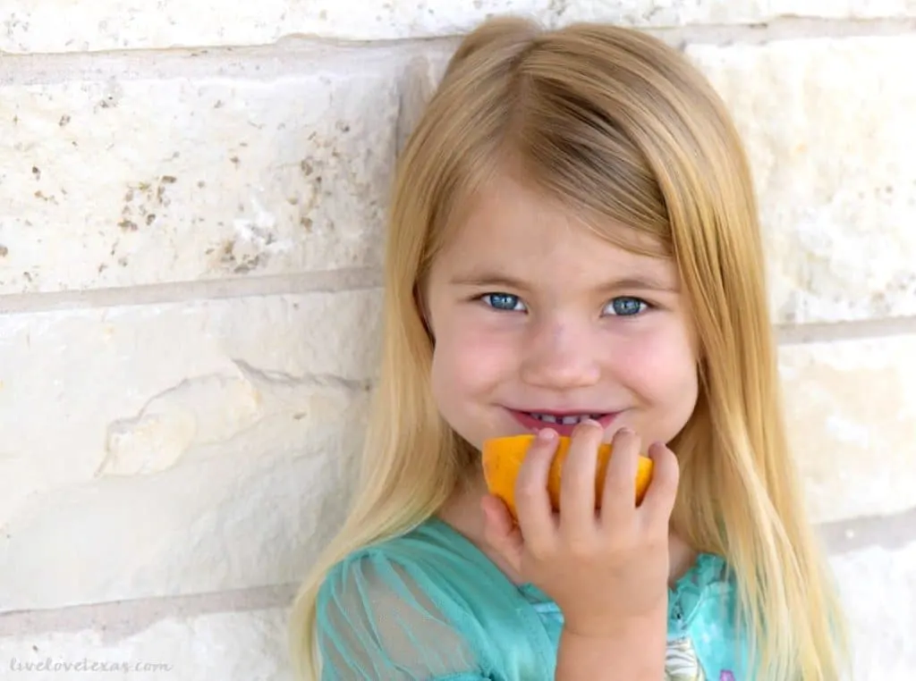 Girl eating grapefruit