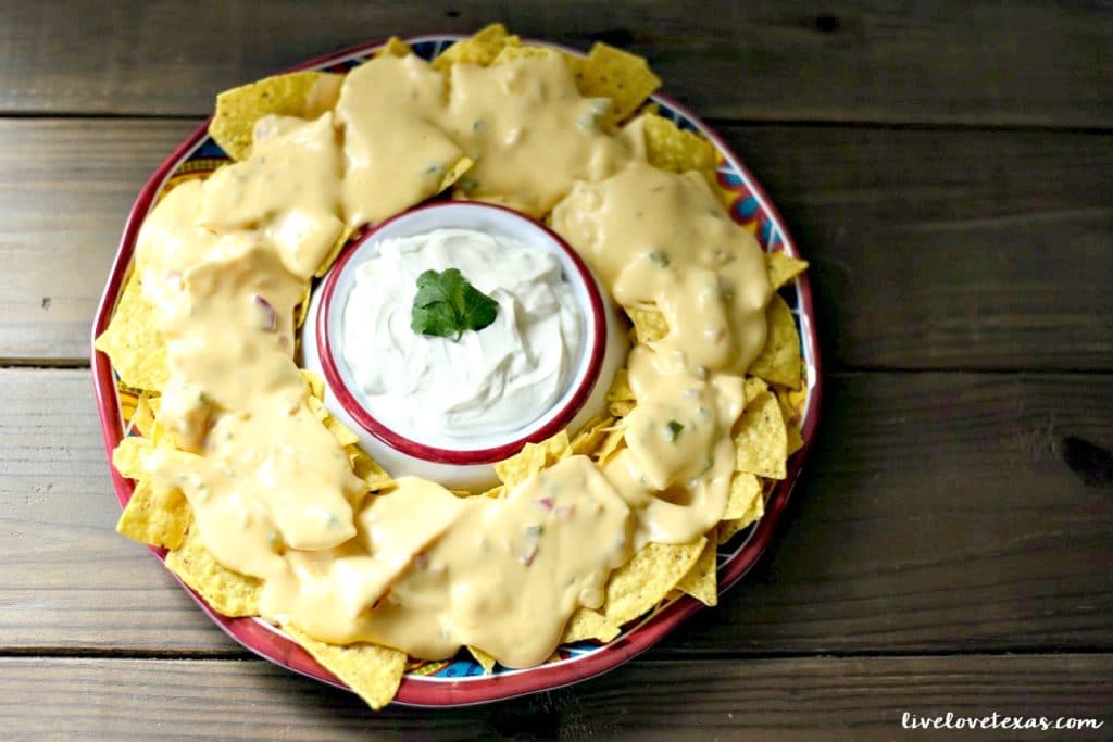 Enjoy nachos at home with a twist. These are the Best Tex Mex Nachos topped with an Easy Homemade Queso Dip Recipe...and without boxed, processed cheese! 