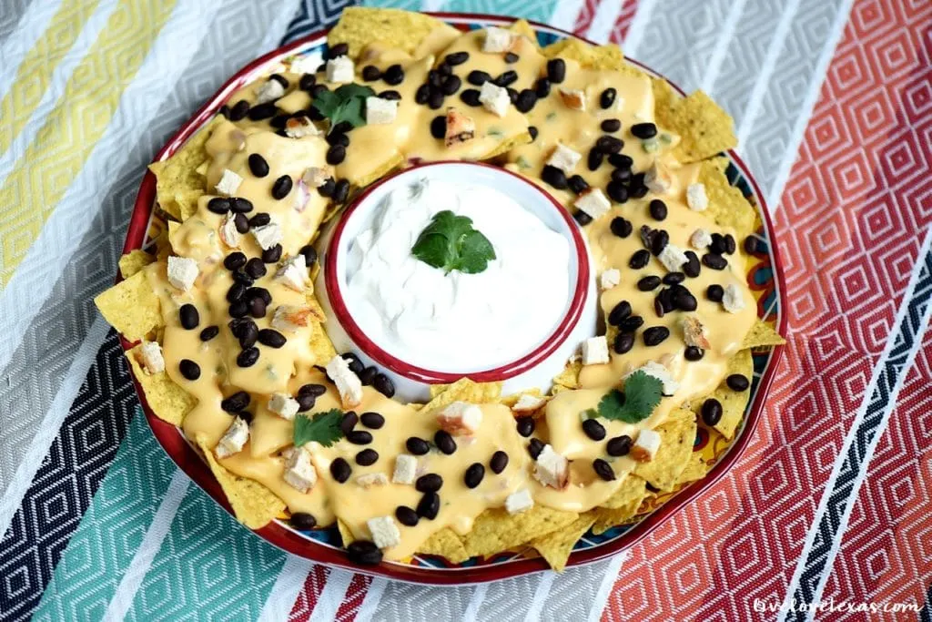 Enjoy nachos at home with a twist. These are the Best Tex Mex Nachos topped with an Easy Homemade Queso Dip Recipe...and without boxed, processed cheese! 