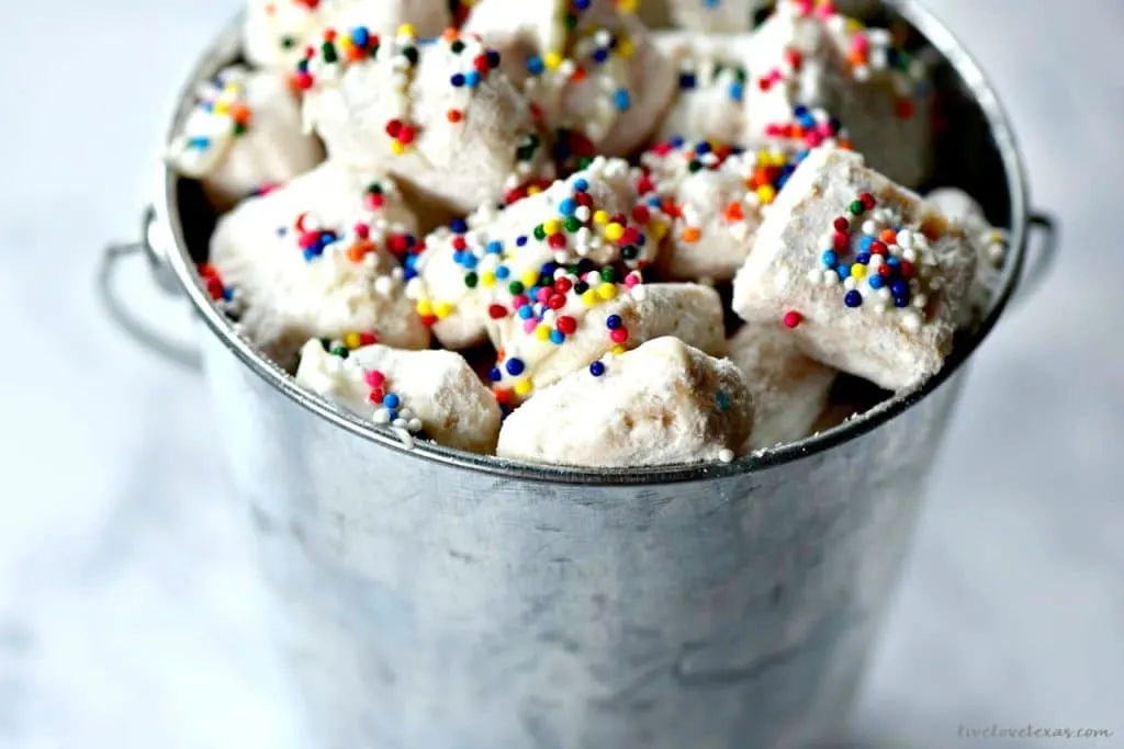 Traditional puppy chow (or muddy buddies depending on what part of the country you're from) is so boring. This puppy chow recipe gets more flavorful and delicious with the addition of funfetti cake batter and this SECRET ingredient!