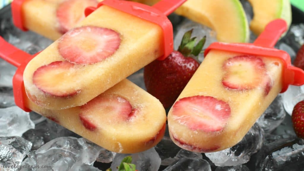 Summer is officially here! To cleebrate (and cool off just a bit), try making this easy homemade Strawberry Cantaloupe Popsicles recipe! This is such a great way to allow kids to help in the kitchen and enjoy a healthy snack afterwards! 