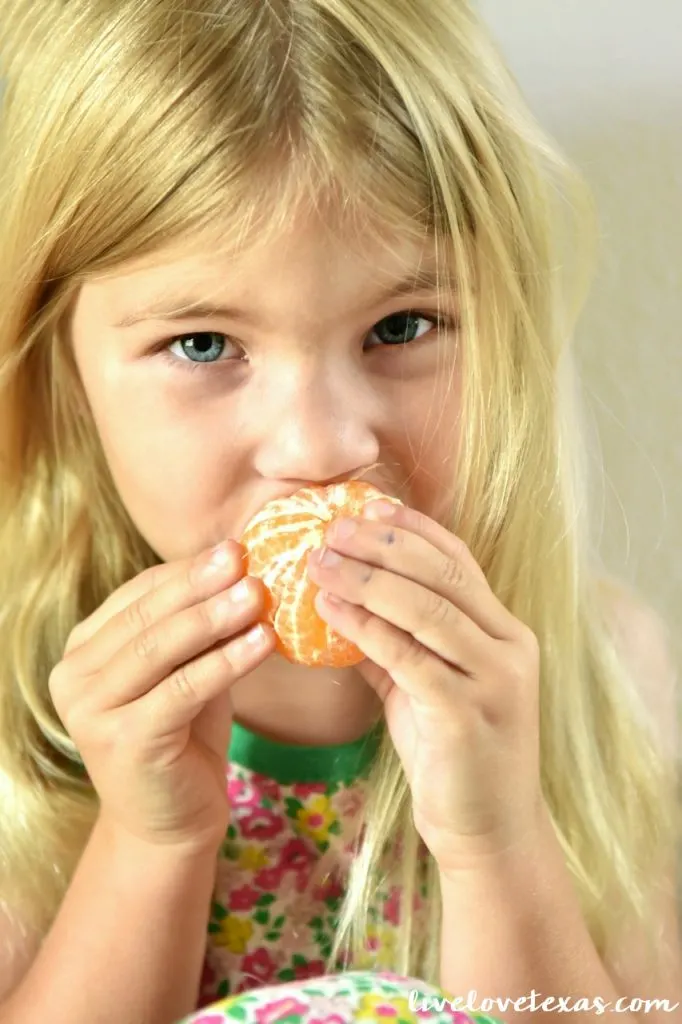 Girl eating fresh fruit