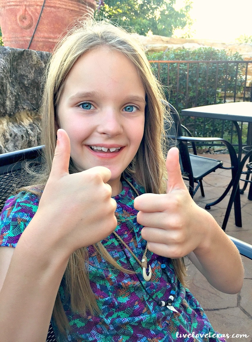 Girl giving two thumbs up to Cheddar's Scratch Kitchen review.