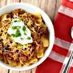 This easy crockpot chili recipe is the perfect midweek dinner or perfect for tailgating. Plus, learn how to turn your leftovers into Frito Pie on day two!