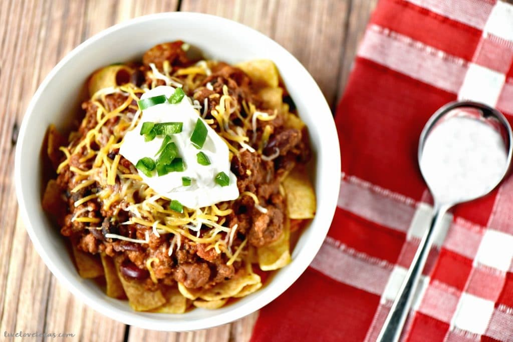 This easy crockpot chili recipe is the perfect midweek dinner or perfect for tailgating. Plus, learn how to turn your leftovers into Frito Pie on day two! #recipe #recipes #chilirecipe #chili #groundbeefrecipes #groundbeef #easychili #slowcookerrecipes #slowcooker #crockpot #crockpotrecipes #crockpotchili #fritopie #soup #chilibeans