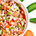 Ditch the store-bought salsa and make your own with this Easy Homemade Salsa Recipe with Fresh Tomatoes & Peppers. It's fast and simple to make to make and tastes great as a topping or with chips!