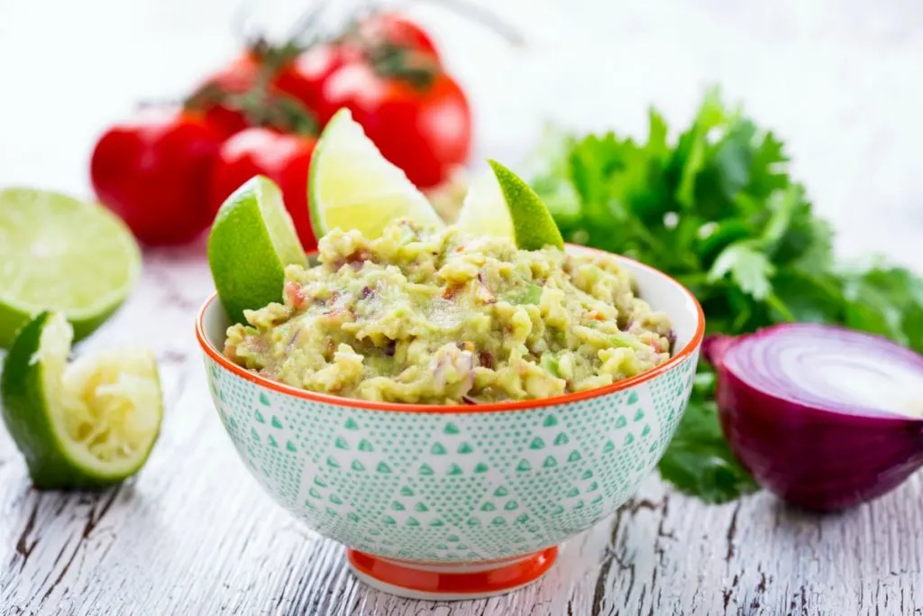 This is the very best homemade guacamole recipe you'll find. Avocados, tomatoes, onions, peppers, cilantro, and lime magically come together to form a guacamole recipe easy and quick dip perfect for any Mexican recipe. If you're looking for a guac recipe that's better than restaurants and will leave you licking the bowl, this is the one for you!