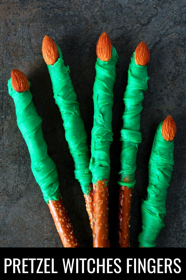 This dipped Halloween pretzels witches fingers recipe is so easy to make and perfect for a dessert or party. These witches fingers are the right balance between a salty and sweet snack and come together in minutes! If you want an easy Halloween dessert that's homemade and a crowd pleaser, you'll want to try these Halloween pretzel rods! #witchfood #witchesfingers #halloweenfood #pretzeldesserts #pretzelrecipe #dippedpretzels #recipes #fallfood #fallsnacks #snacks #kidsrecipes #kidsnacks