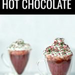 Your entire kitchen will smell like winter heaven when you serve this red velvet hot chocolate! This is an easy holiday drink recipe but served in a clear glass mug makes a stunning presentation. #sponsored #redvelvet #hotchocolate #hotcocoa #drinkrecipes #hotdrinks #holidaydrinks #holidayrecipes #christmasrecipes #redvelvethotchocolate #redvelvetrecipes