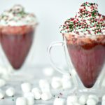 Your entire kitchen will smell like winter heaven when you serve this red velvet hot chocolate! This is an easy holiday drink recipe but served in a clear glass mug makes a stunning presentation.