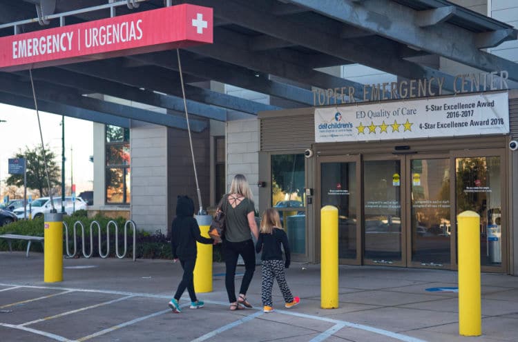 mom and kids entering dell children's medical center emergency department in austin texas