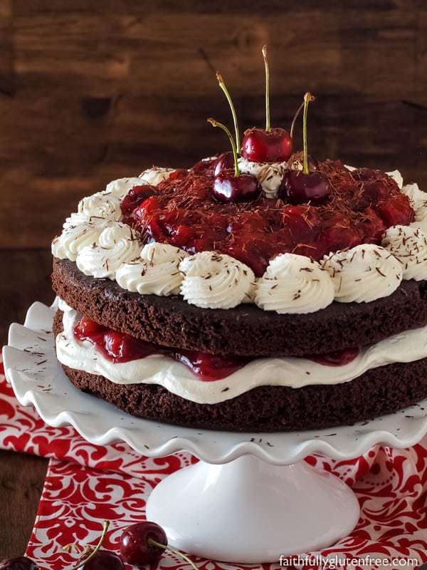 Flourless Black Forest Cake with whipped cream and fresh cherries.