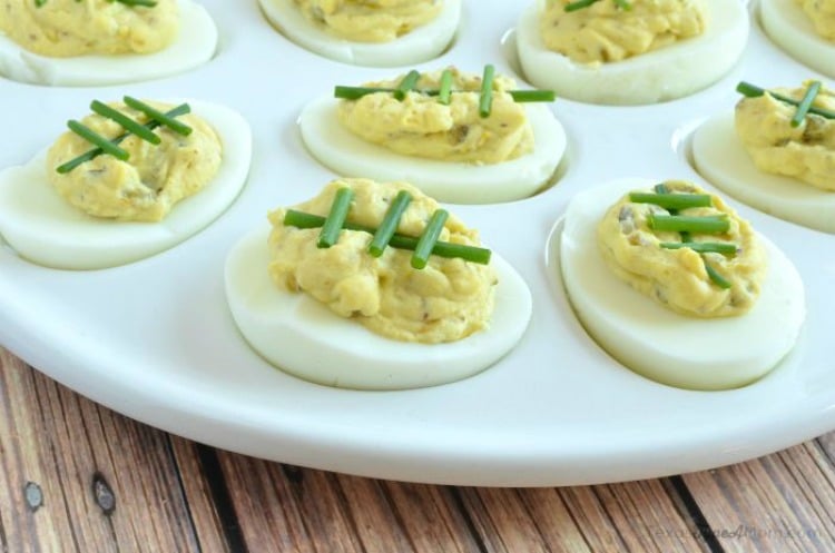 Spicy deviled egg footballs with chives for laces
