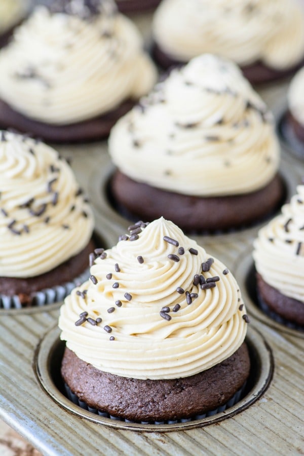 Bailey's Irish Cream Chocolate Cupcakes in pan topped with Bailey's Buttercream Frosting.