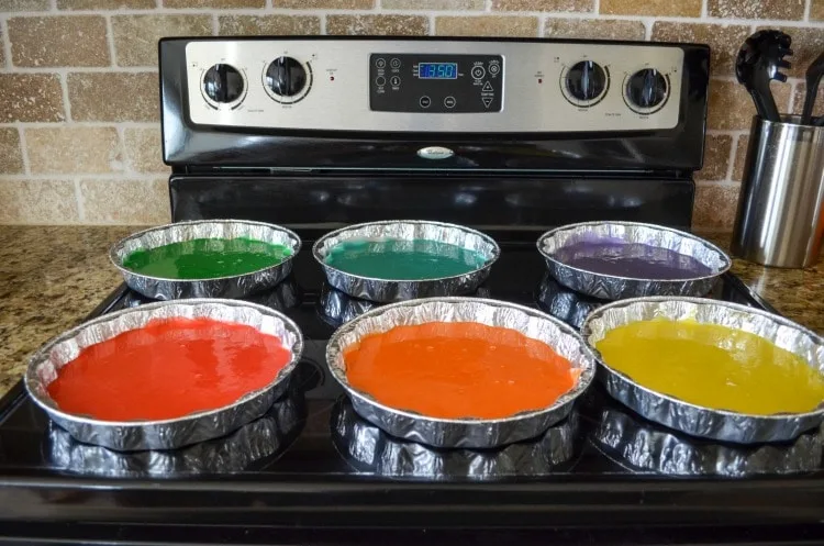 Big rainbow layer cake with individual colors baked.