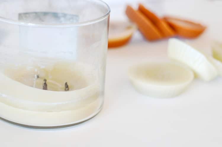 Homemade candle tart melts next to used candle with leftover wax.