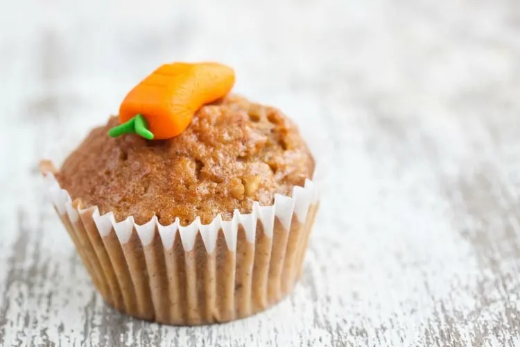 Kid friendly carrot muffin with carrot icing on top.