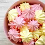 Meringue cookies in a pink bowl.