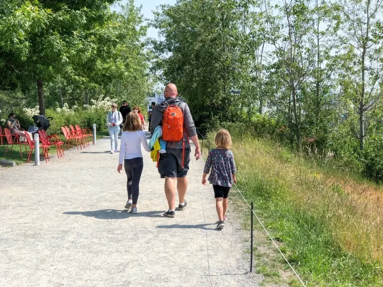 Dad and daughters walking in Sculpture Garden in Seattle, Washington