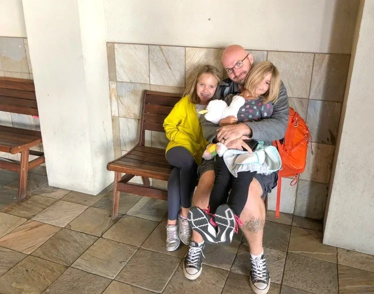 Father and daughters waiting for Seattle shuttle at Silver Cloud Hotel in the Stadium District.