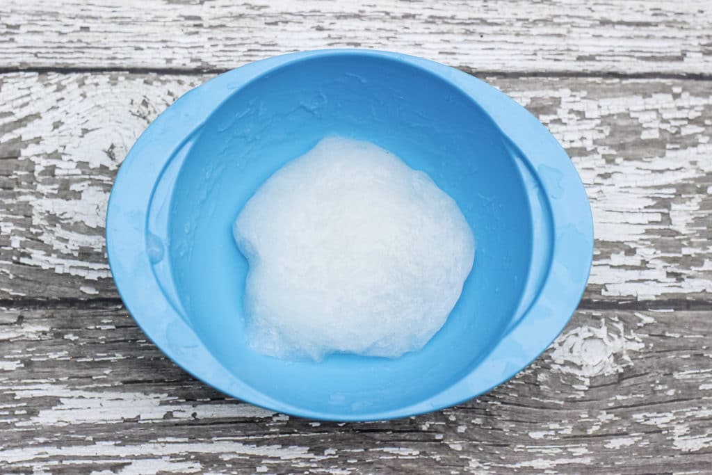 DIY Kinetic Sand Slime in blue bowl.