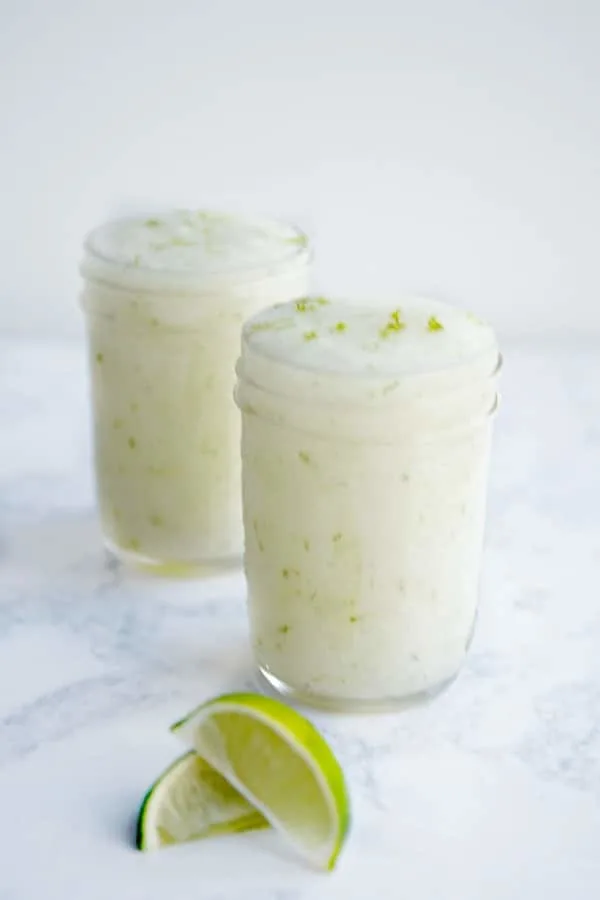 Two mason jars filled with lime sugar scrub.