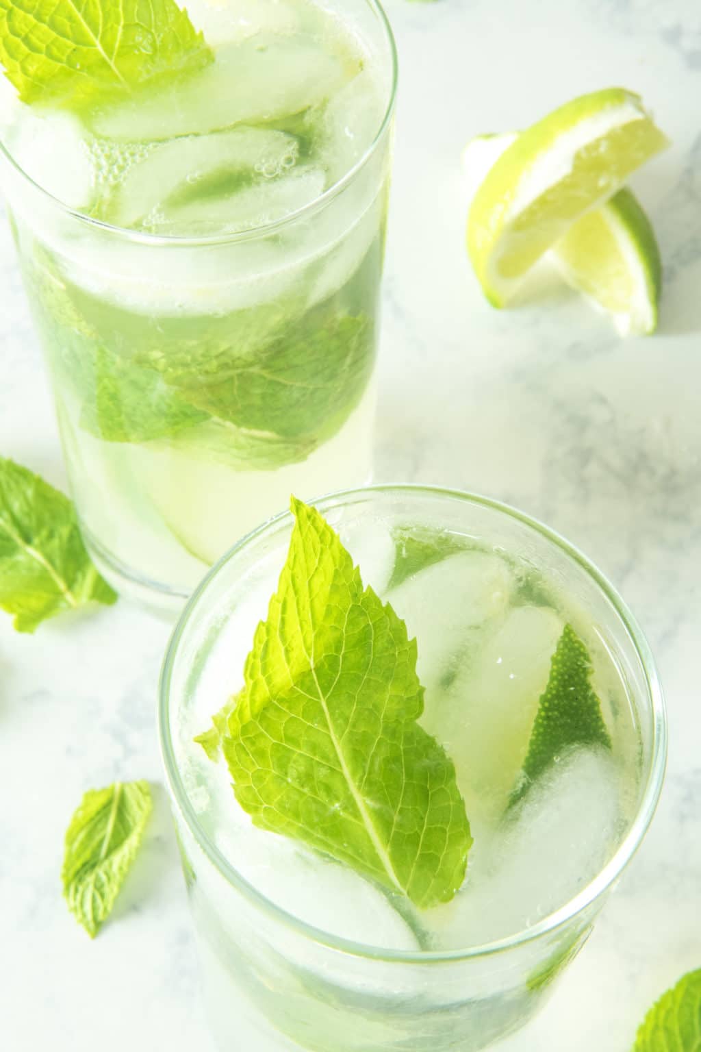 Skinny mojitos in glasses with rum, fresh lime juice, mint, and sugar free syrup