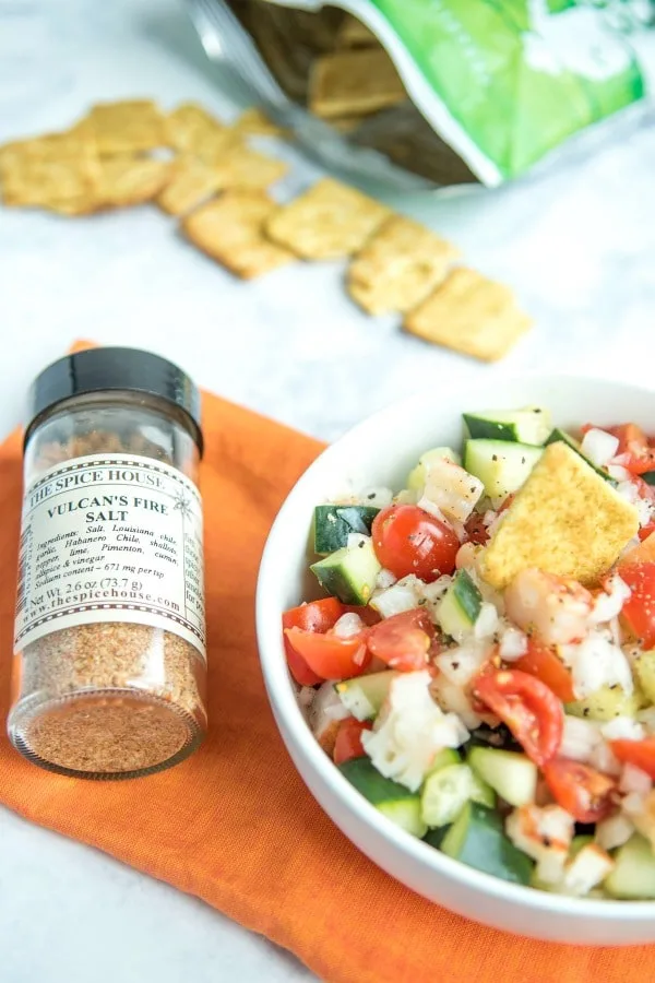 Spicy grilled shrimp salad in bowl with seasoning.
