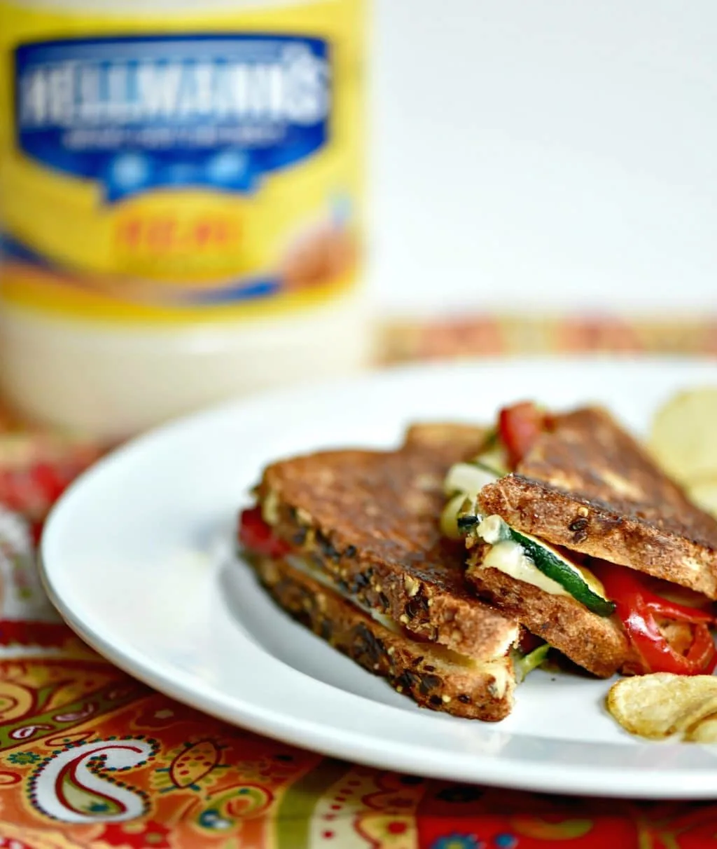 Zucchini grilled cheese sandwiches with mayo instead of butter on a plate with chips