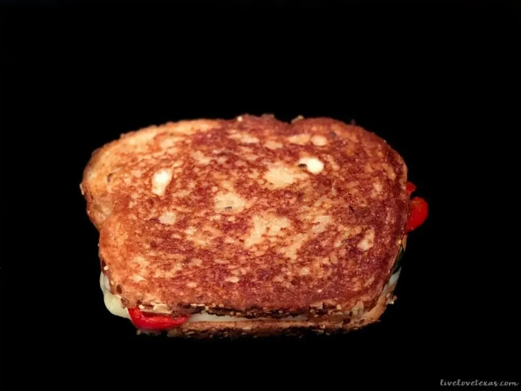 Veggie filled grilled cheese sandwich in pan