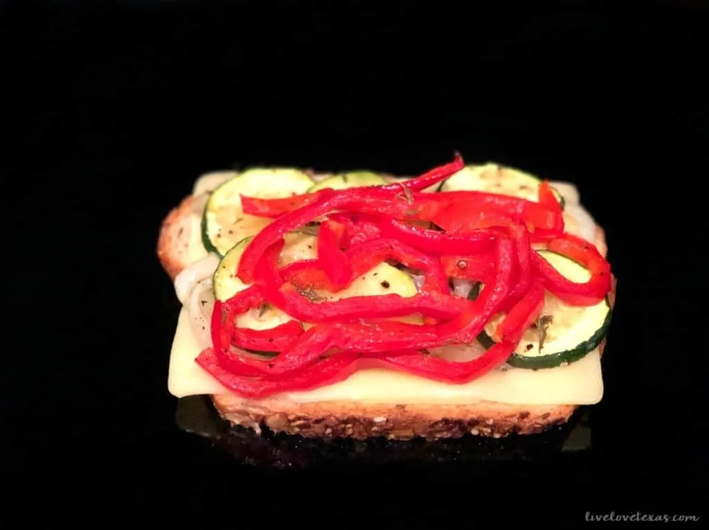 Bread with mayo cheese and veggies in skillet