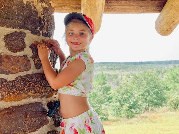 Girl posting at scenic overlook at Bastrop State Park