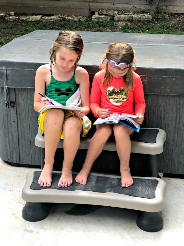 Girls reading outside to avoid summer slide