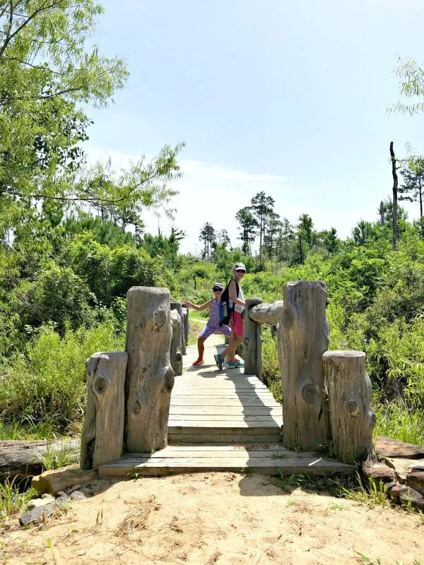 Girls posing on a bridge in Bastrop State Park
