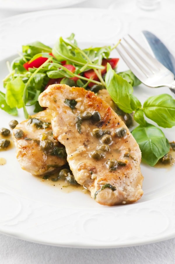 When you're looking for an easy chicken recipe that's kid friendly but also perfect for company, then you want this lemon piccata. This lemon caper chicken recipe is easy to make and can has modifications for gluten free and low carb diets. #chicken #chickenrecipes #lemonchicken 