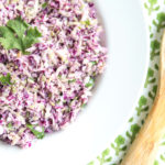 Low Carb Coleslaw in bowl with wooden serving spoon