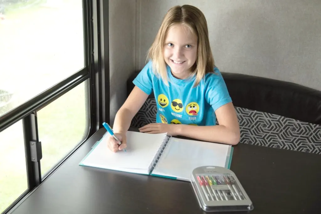Girl with ADD taking notes with colored pens.