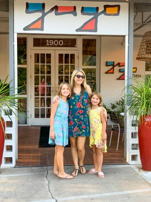 Mom and daughters standing in front of Yuyo Restaurant in Austin Texas