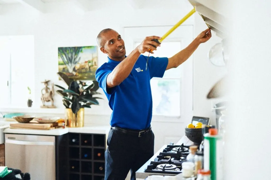 Best Buy service tech measuring home for new technology