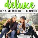 Ion Boombox Deluxe Speaker Hero with two teenage girls using bluetooth from phone to control music