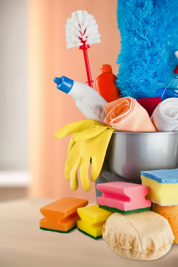 Bucket full of cleaners and supplies for house cleaning hacks for moms