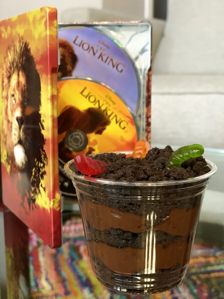 Oreo Pudding Cups with The Lion King movie in front of with colorful rug