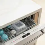 Open dishwasher with clean dishes inside.