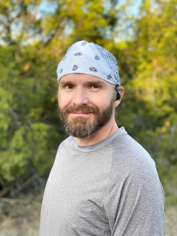 Man ready to run with wireless earbuds.