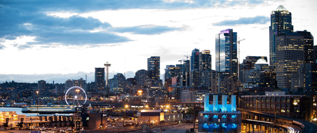 The Seattle skyline and waterfront with the Great Wheel, Space Needle, and Smith Tower.